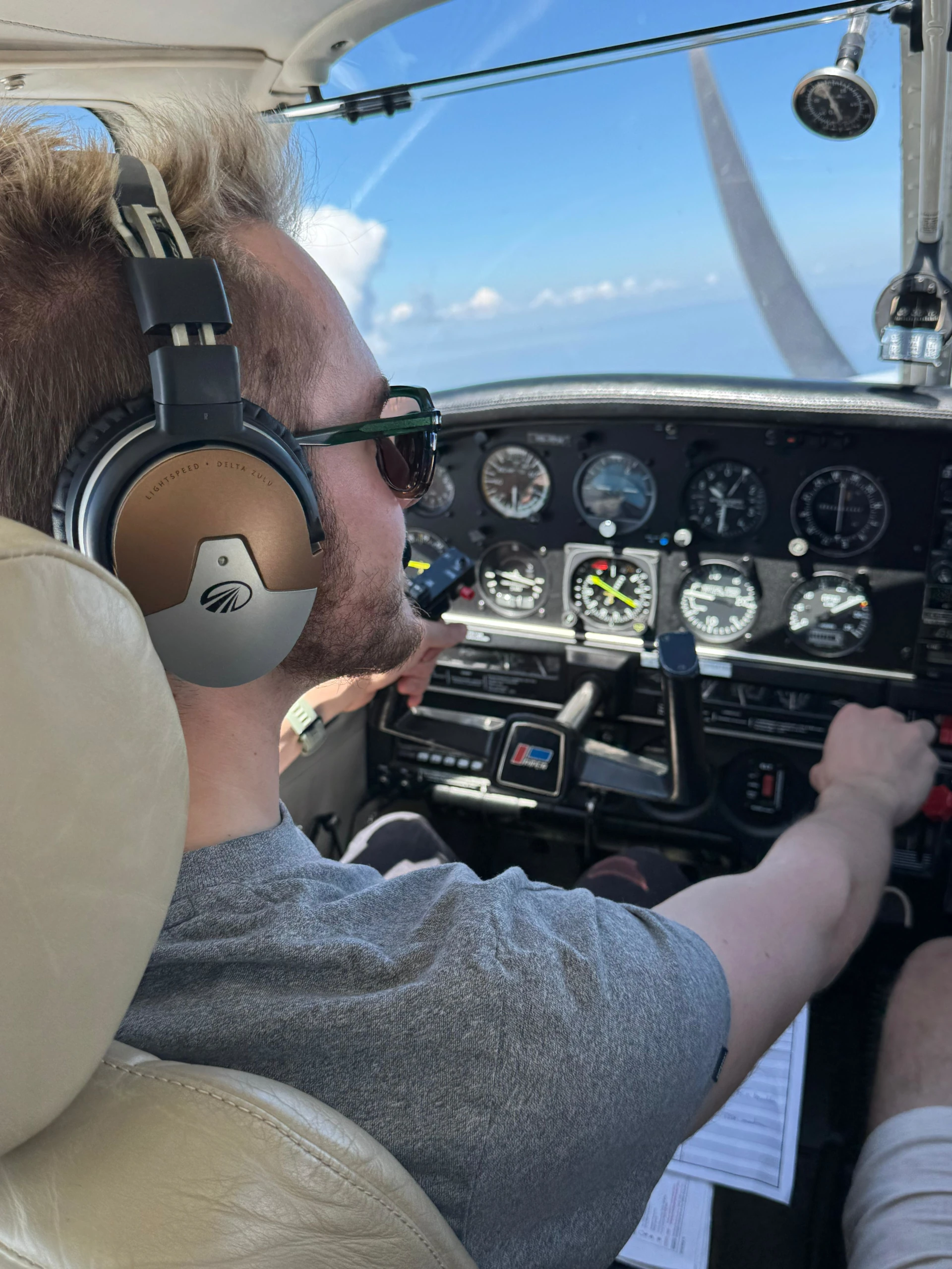 Leon wearing a headset in the cockpit